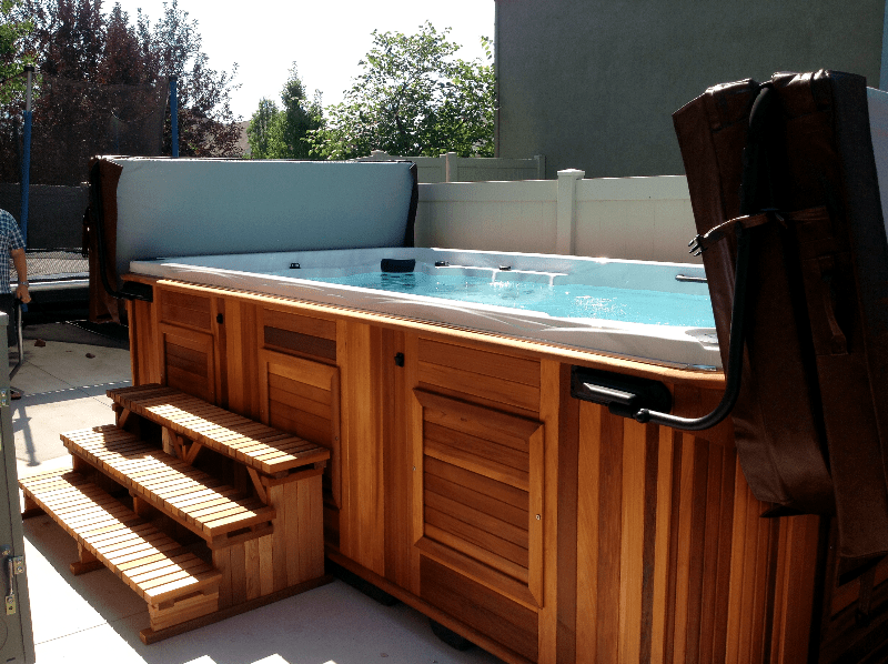 Arctic Spas swim spa with open covers in the backyard